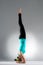 Young female yoga student handstand on floor