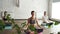 Young female yoga students are meditating in lotus position in the end of practice in beautiful light studio. Relaxation