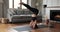 Young female yogi practice supported headstand asana at home