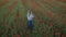 Young feminine blogger woman in flower field