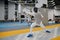 Young fencer practicing attack in training room after lesson