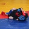 Young fighters in sports protection on the wrestling mat cover