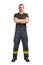 Young firefighter with folded arms wearing black t-shirt and fireproof pants with suspenders isolated