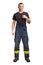 Young firefighter wears black t-shirt standing and pull suspender on his fireproof pants isolated