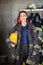 Young Firewoman Holding Helmet At Fire Station