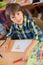 Young first grade student sitting at desk on his first day at sc