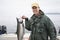 Young fisherman in Alaska holds up a nice silver salmon