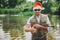 Young fisherman fishing on lake or river. New year period or Christmas time. Guy holding rod for fishing. Festive time