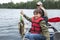 Young fisherman proudly holds stringer of walleyes