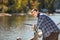 Young fisherman with rod and sunglasses fishing in lake