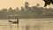 The young fishermen is floating on the lake, people on a boat