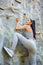 Young fit beautiful girl climbing outdoor on a artificial rock