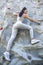 Young fit beautiful girl climbing outdoor on a artificial rock