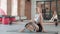 young fit caucasian smiling woman sitting on mat, holding pilates ring at gym