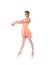 A young and fit female ballet dancer in an orange dress