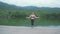 Young fit happy Asian woman jumping rope at an outdoor nature park with lake and montain view, healthy lifestyle