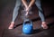 Young fit muscular strong girl preparing putting sport chalk on her hands for heavy kettlebell cross swing workout training in the