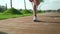 Young fit sporty active black woman running in sneakers in city park outdoors.