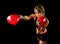 Young fit and strong attractive boxer girl with red boxing gloves fighting throwing aggressive punch training workout in gym