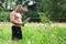 Young fit topless bodybuilder outdoors demonstrating muscles