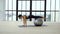 Young fit woman doing exercises with fitness ball in studio