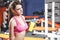 Young fit woman with energy drink relaxing and drinking in the gym. Sport and fittness concept