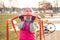 Young fit woman in fitness clothes pulls up on workout crossbar outdoors