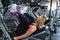 Young fit woman at the gym doing leg muscle exercise with leg pr