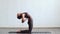 Young and fit woman practicing yoga indoor in the class. Stretching exercise in the day light. Sport, fitness, health