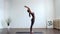 Young and fit woman practicing yoga indoor in the class. Stretching exercise in the day light. Sport, fitness, health