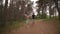 Young fitness couple running at the forest trail