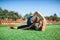 Young fitness girl doing stretching in the sunset . Football field.