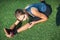 Young fitness girl doing stretching in the sunset . Football field close-up.