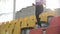 Young fitness runner in sportswear running down the ladder of tribune at stadium