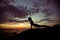 Young fitness woman exercise on the ocean coast at twilight. Y