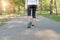 Young fitness woman legs walking in the park outdoor, female runner running on the road outside, asian athlete jogging and exercis