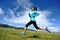 Young fitness woman runner running on beautiful trail in grassland