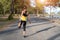 Young fitness woman runner stretching legs before run on city, Young fitness sport woman running on the road in the morning