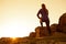 Young Fitness Woman Stretching her Legs in the Mountains at Sunset. Female Runner Doing Stretches Outdoor. Healthy Lifestyle Conce