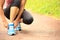 Young fitness woman tying shoelaces