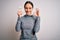 Young fitness woman wearing sport workout clothes holding paper with diet word doing ok sign with fingers, excellent symbol