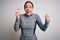 Young fitness woman wearing sport workout clothes holding paper with diet word screaming proud and celebrating victory and success