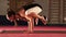 Young flexible Female doing yoga Crane pose