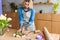 young florist in apron arranging beautiful tulips