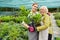 Young florist and senior gardener as a nursery team