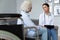 Young focused nurse visiting disabled patient at home.