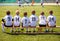 Young Football Players. Young Soccer Team Sitting on Wooden Bench