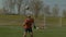 Young footballer heading soccer ball on the field