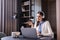 young freelancer in headphones sitting near laptop in restaurant.