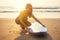 Young freelancing woman in a wetsuit swimming over surfboard in the water at beach.surfer girl relaxing in paradise